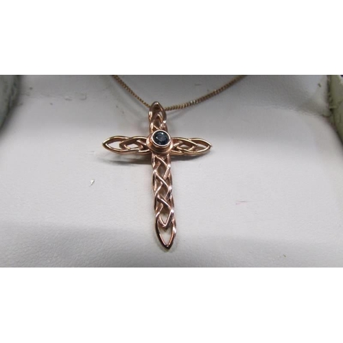 100H - A Clogau stone set gold cross on chain, 3.6 grams.