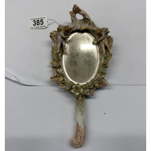 385 - A continental ceramic hand mirror with bevel edge glass