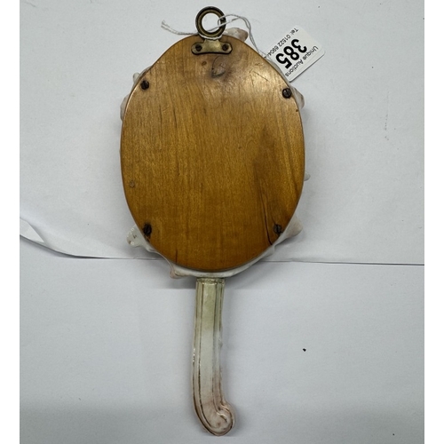 385 - A continental ceramic hand mirror with bevel edge glass