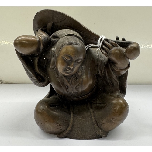 386 - A Bronze Buddha with a mandolin.