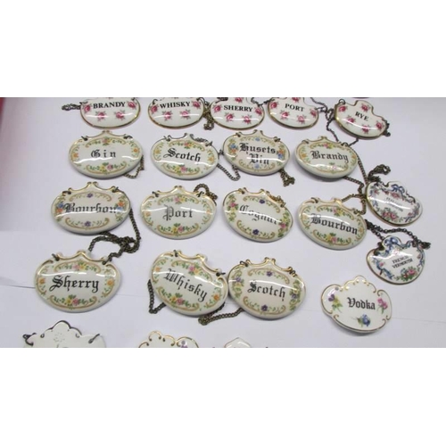 213 - Forty four ceramic decanter labels including sets.