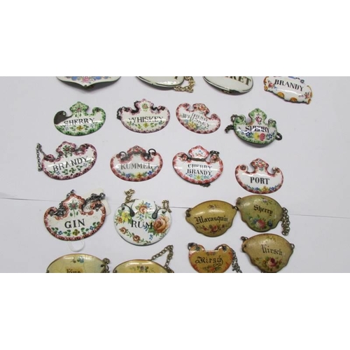 214 - Thirty enamel decanter labels and three others.