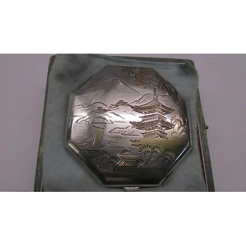 222 - A heavy silver powder compact with oriental gilding engraving dedicated to Joy, Tokyo 1958.