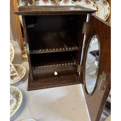 398 - An Edwardian oak smokers cabinet