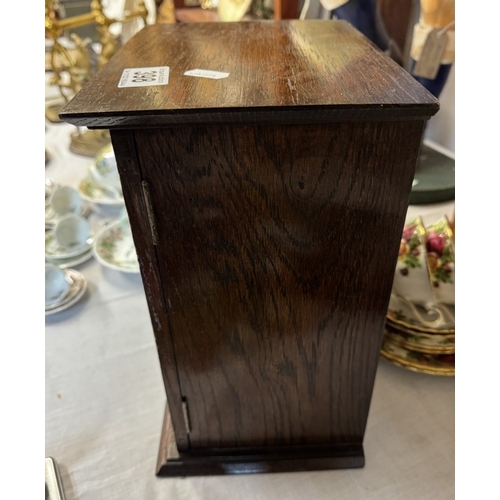 398 - An Edwardian oak smokers cabinet