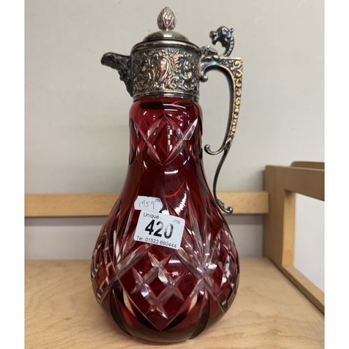 420 - A deep cut cranberry overlaid glass claret jug