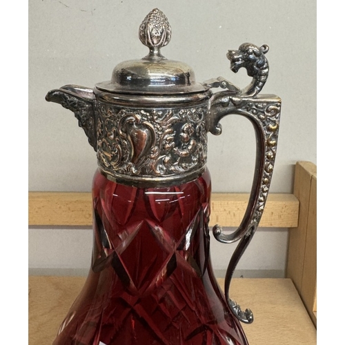 420 - A deep cut cranberry overlaid glass claret jug