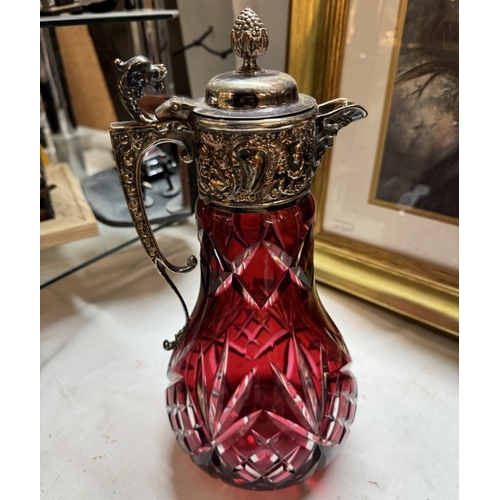 420 - A deep cut cranberry overlaid glass claret jug