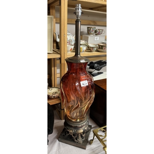 425 - A tall red glass table lamp on metal base, will need re-wiring, (no shade)