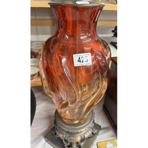 425 - A tall red glass table lamp on metal base, will need re-wiring, (no shade)