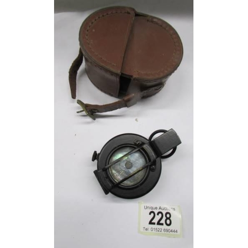 228 - A leather cased army compass.