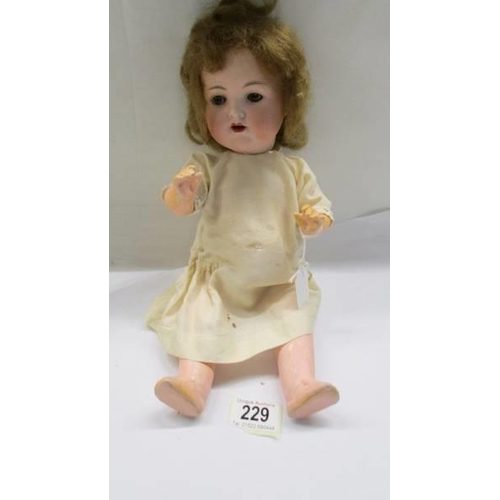 229 - A German Armande Marsielle A-2-M 990 porcelain headed doll with composition body.