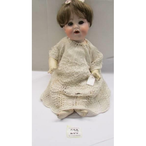 230 - A German Armande Marsielle A-4-M 990 porcelain headed doll with composition body.