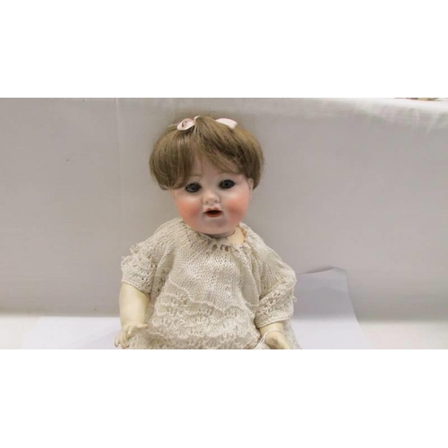 230 - A German Armande Marsielle A-4-M 990 porcelain headed doll with composition body.