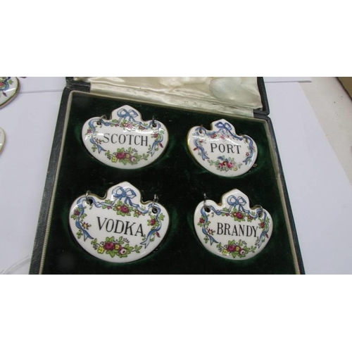 263 - A quantity of ceramic decanter labels including four in a case.