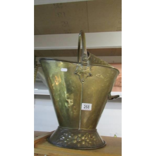 268 - A good old brass helmet shaped coal scuttle.