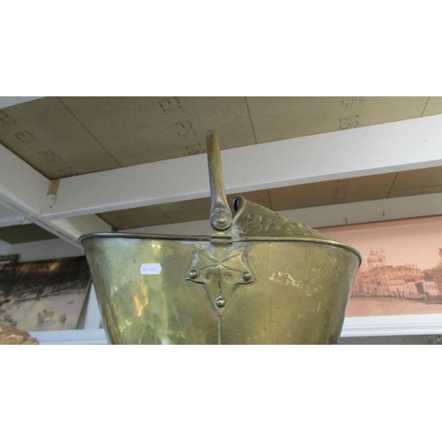 268 - A good old brass helmet shaped coal scuttle.