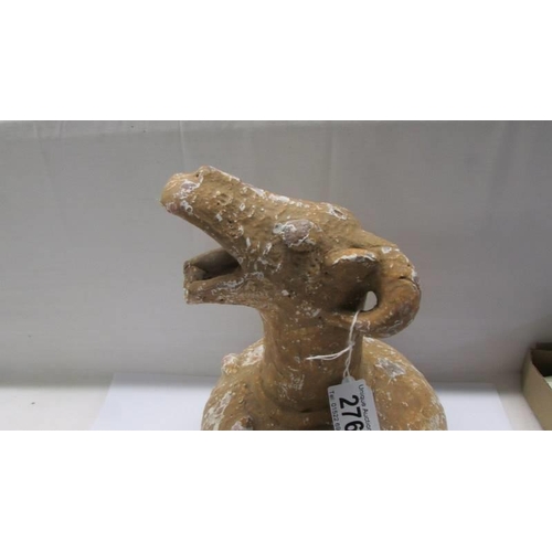 276 - An antique terracotta jug with goats head spout.