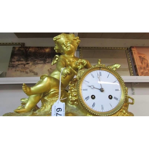 279 - A gilded 19th century mantel clock surmounted cherub and with porcelain panels.