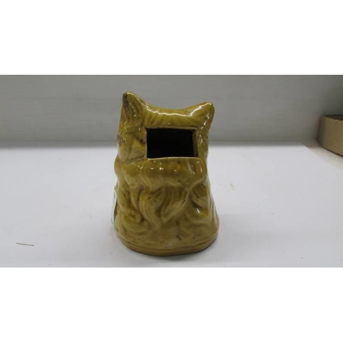 280 - A early ceramic money box in the form of a dogs head.