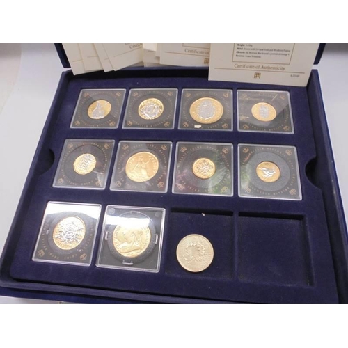 290 - Eleven gold plated commemorative coins with certificates in a case.