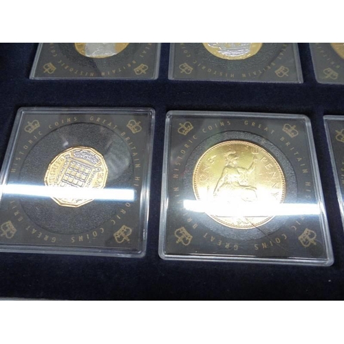 290 - Eleven gold plated commemorative coins with certificates in a case.