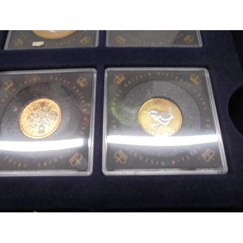 290 - Eleven gold plated commemorative coins with certificates in a case.