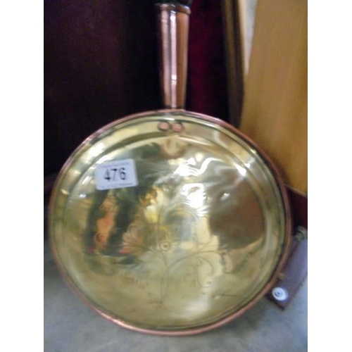 476 - A Victorian brass and copper warming pan.