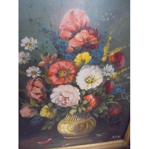 492 - A gilt framed oil on canvas floral display initialed S A H, image 49 x 39 cm, frame 52 x 62 cm.