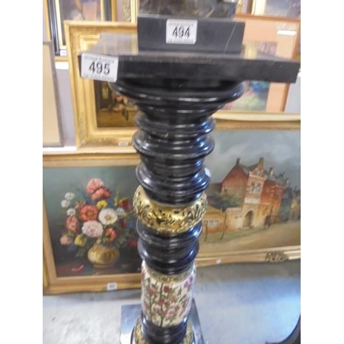 495 - A good torchere with brass and ceramic insets.