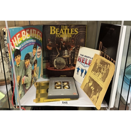 545 - A quantity of Beatles reference books including figures, drum kit & DVD's etc (2 shelves)