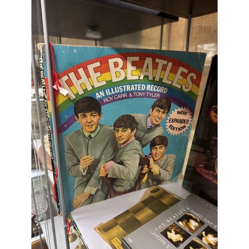 545 - A quantity of Beatles reference books including figures, drum kit & DVD's etc (2 shelves)