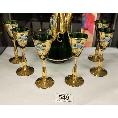 549 - A green glass & gilt decanter with 6 glasses