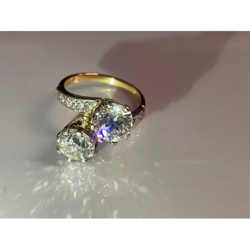 52 - An 18ct gold ring set two x two carat diamonds, size O, total weight 7.4 grams.