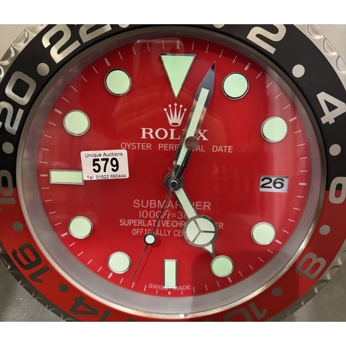 579 - A wall clock in the style of a Rolex watch