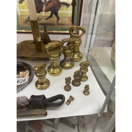 626 - A quantity of brassware including weights & candlesticks etc