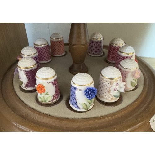 641 - A collection of fine porcelain thimbles on stand