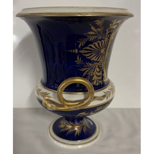 677 - A Derby cobalt ground vase of campana form with gilt snake handles, painted with a traveller in a wo... 