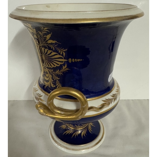 677 - A Derby cobalt ground vase of campana form with gilt snake handles, painted with a traveller in a wo... 