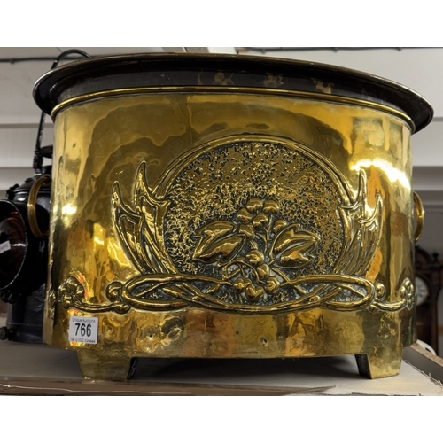 766 - A large heavy brass log bin with art nouveau decoration