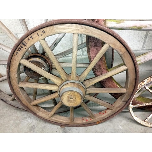 1505 - 3 large wooden cart wheels & a smaller metal wheel