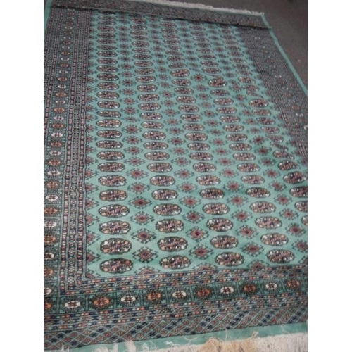 1163 - A green patterned rug, 186 x 274 cm