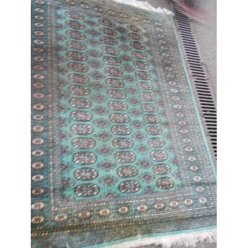 1165 - A green patterned rug, 130 x 180 cm