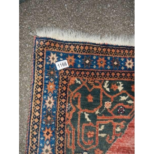 1166 - A red patterned Persian rug. 85 x 130 cm