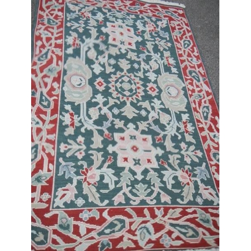 1168 - A red patterned rug, 116 x 182 cm.