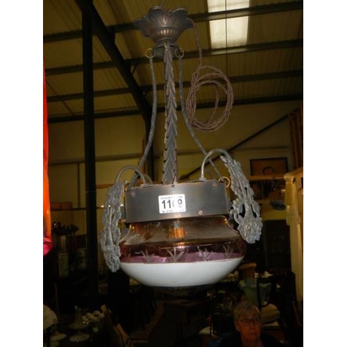 1169 - A mid 20th century ceiling light with glass cranberry edged shade.