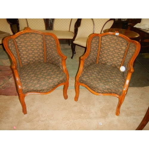 1179 - A pair of Edwardian mahogany framed arm chairs.