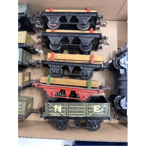 809 - A quantity of Hornby O gauge rolling stock including wagons & flat wagons with planks etc.