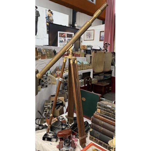 1668 - A large brass telescope on teak tripod