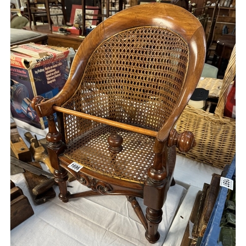 1696 - A vintage child's Bergere wing armchair with spare finial